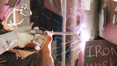 close-up of a welder creating sparks during metal work
