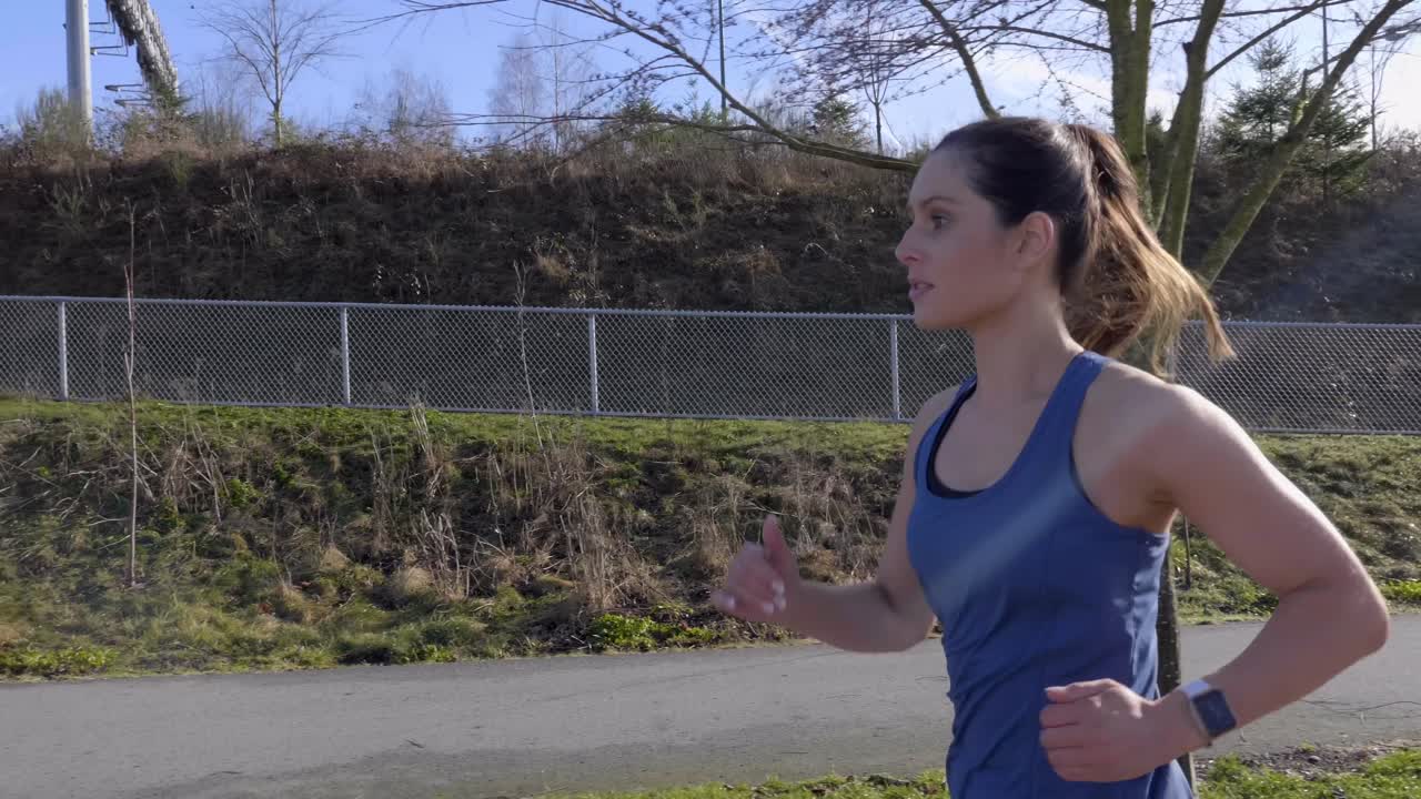 Healthy athletic young woman morning run tracking shot Slow motion