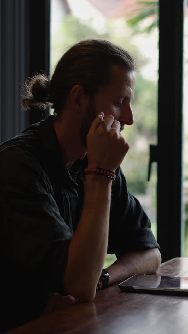 Portrait of a man with a ponytail