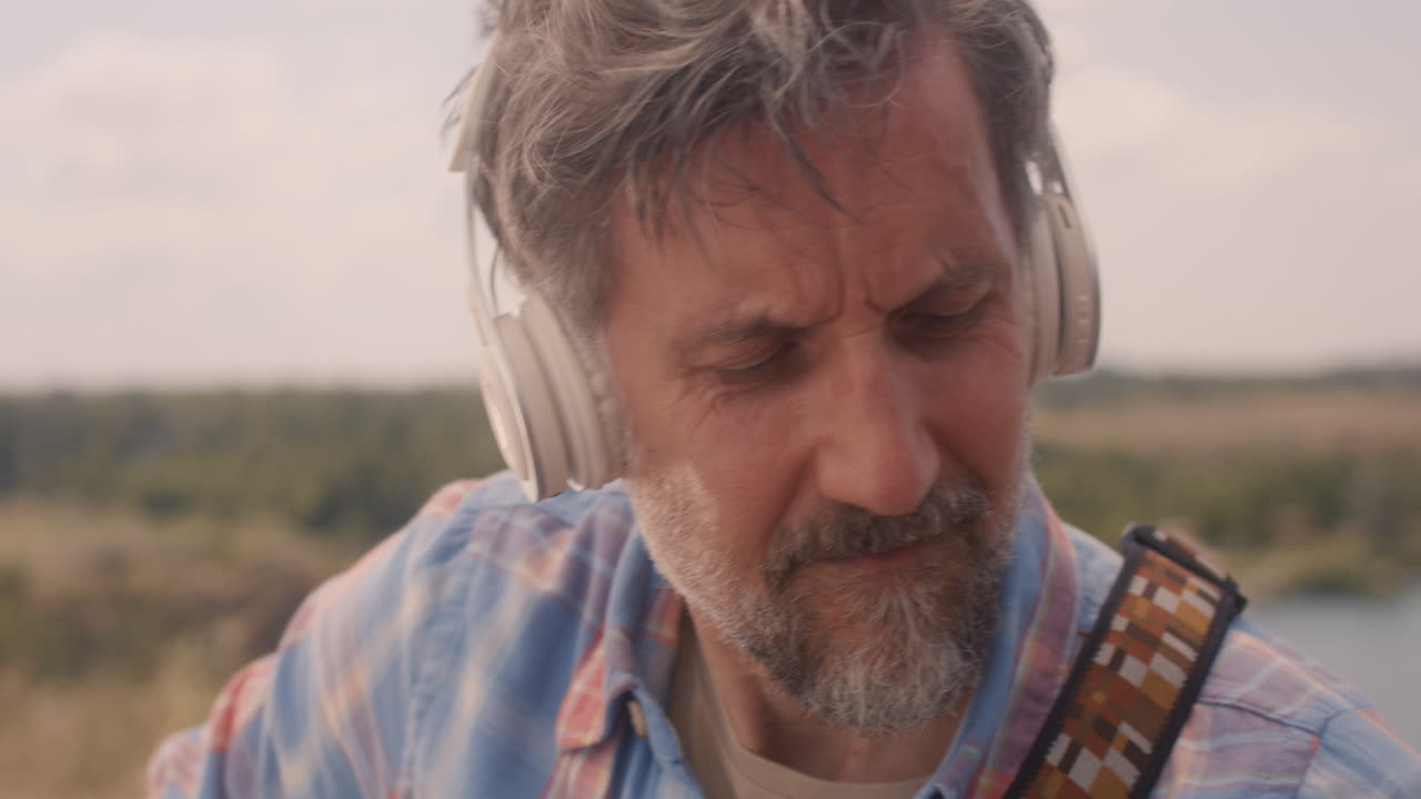 Man Playing Guitar Outdoors