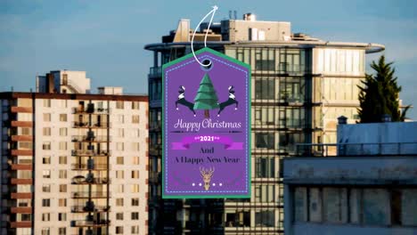 animation of christmas greetings on tag over cityscape in background