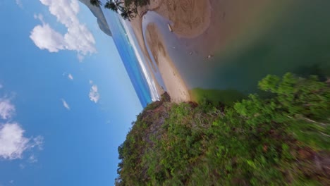 vertical fpv flight over rio san juan floating into caribbean sea during sunny day - playa el valle, samana - establishing shot