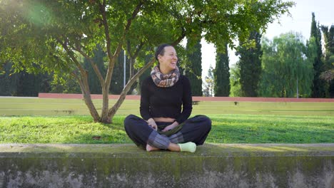 yoga teacher stretching and laughing looks at a student during class