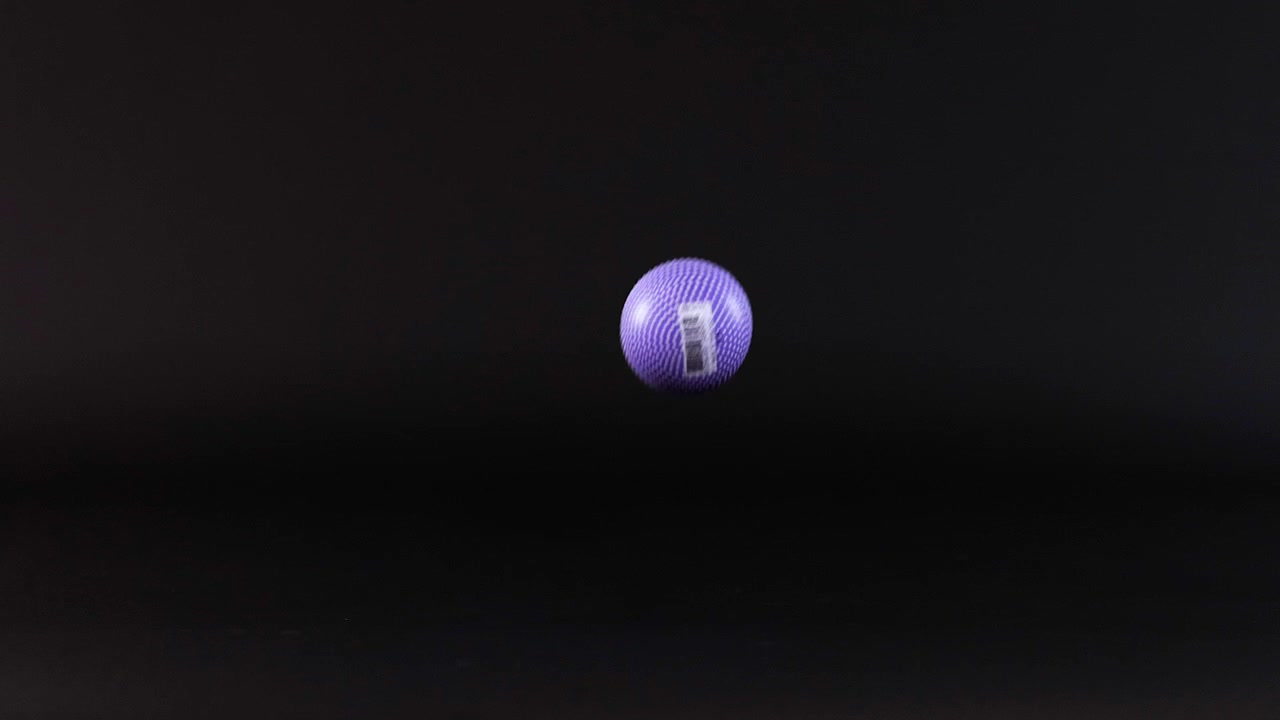 A purple ball bounces against a dark background