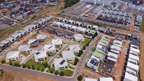 beautiful aerial of an apartment block with photovoltaic solar panels on the rooftops at godab estate, abuja, nigeria
