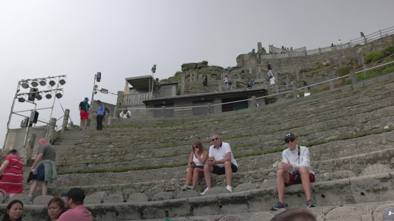 People at an outdoor stone amphitheater