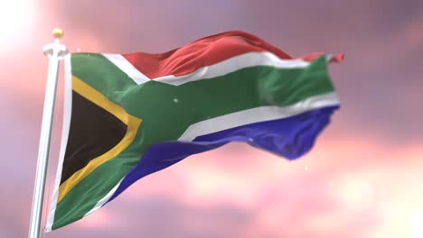 la bandera de sudáfrica ondeando en el viento lentamente al atardecer, bucle