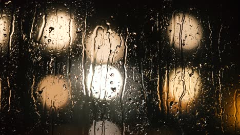 Various-shots-and-camera-movement-of-detailed-rain-drops-falling-on-window