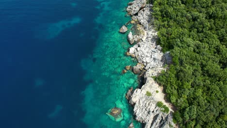 Beautiful-Colors-of-the-Mediterranean-Sea-on-Rocky-Coastline-with-Crystal-Turquoise-Waters,-Azure-Hues,-and-Green-Hills