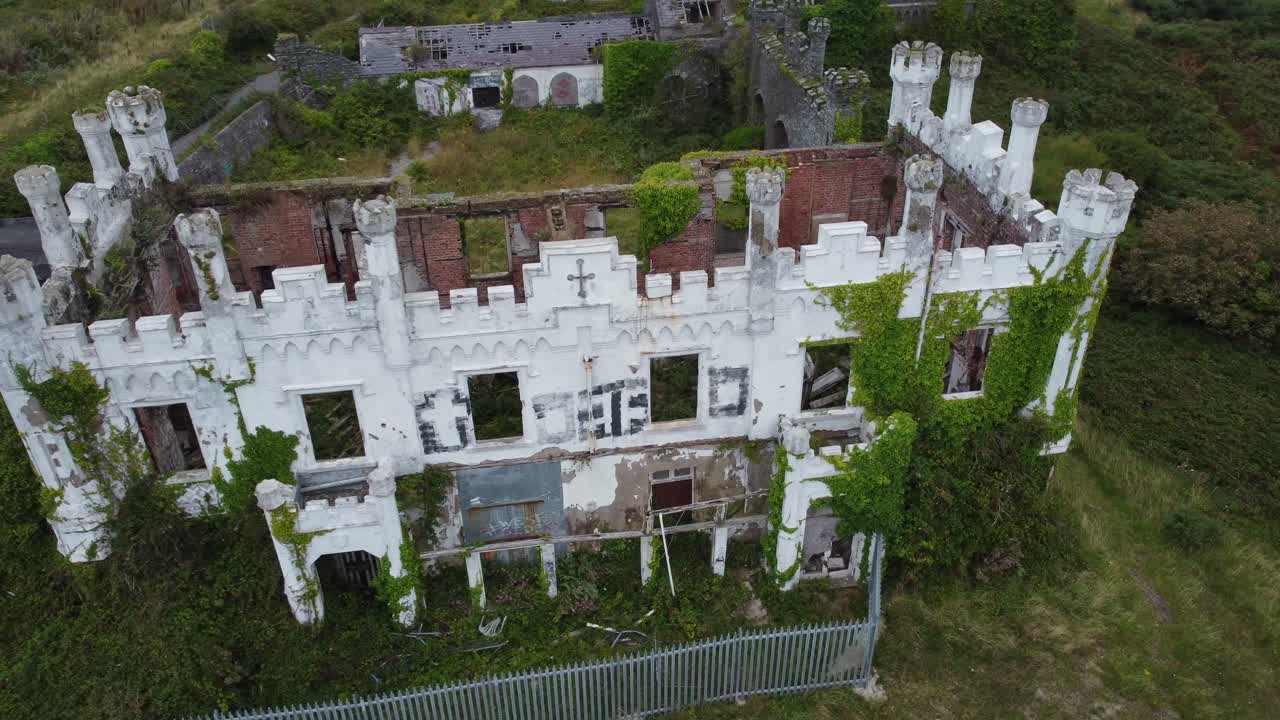 Soldiers point house aerial circling view above abandoned ivy covered Victorian castle mansion