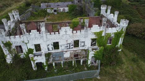 soldiers point house aerial circling view above abandoned ivy covered victorian castle mansion