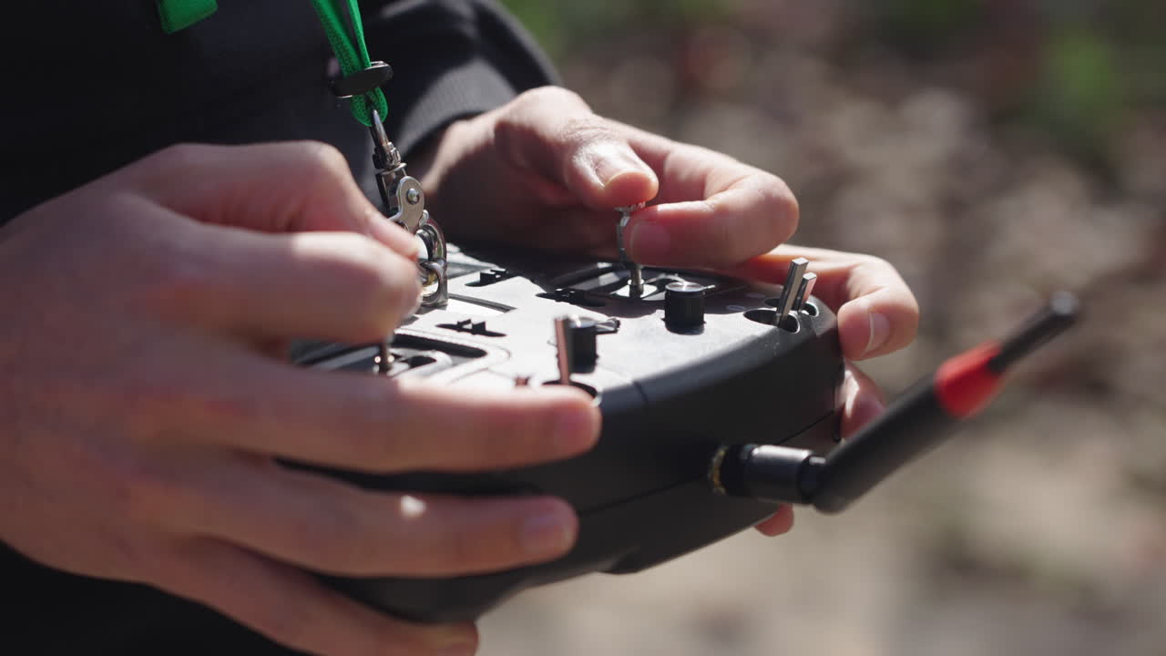 Pilot's Hands Operating Drone Remote Control Joysticks
