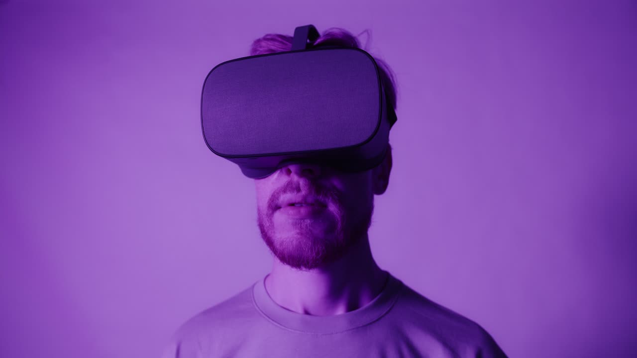 uomo che indossa le cuffie vr in illuminazione viola