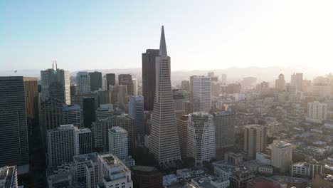 aerial view of a modern city skyline bathed in soft sunlight with skyscrapers and clear blue sky