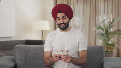 Happy-Sikh-Indian-man-counting-money