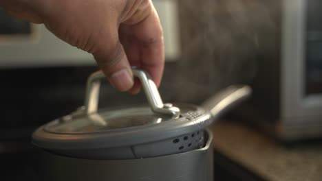 Cooking-rice-on-a-stove-top-burner-cover-pot-to-steam-cook-boiling-water