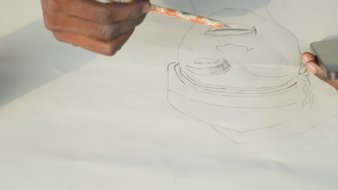 Closeup black artist sketching portrait canvas, steady pencil strokes, soft daylight, careful outline of face and hat, focused hand movements, meditative creative process in studio