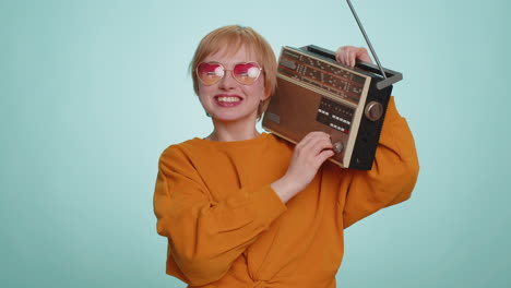 woman using retro tape record player to listen music disco dancing of favorite track having fun