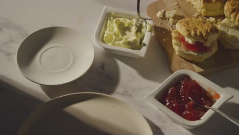 Studio Shot Of Person With Traditional British Afternoon Tea With Scones Cream And Jam 6