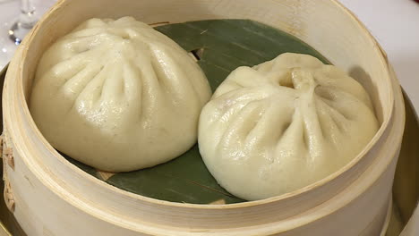 steamed pork buns in bamboo steamer