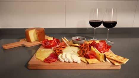 Fancy-dinner-with-a-cheese-plate-and-red-wine-prepared-for-a-romantic-evening