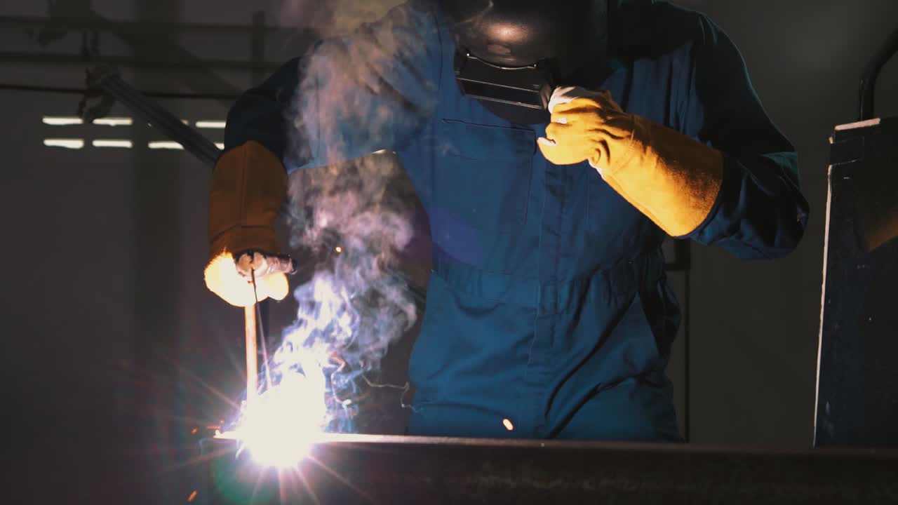 Metal welder working with arc welding machine