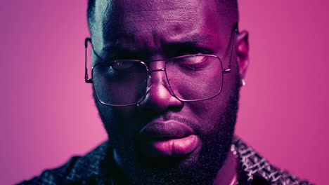 Emotional-man-grimacing-in-studio.-Unpredictable-afro-guy-posing-indoors