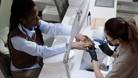 woman getting a manicure at a nail salon