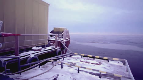 frozen lake scene with ice and tugboat