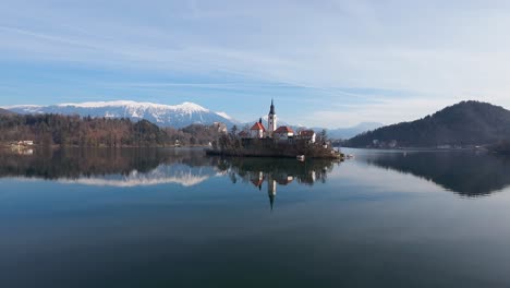 bled church on bled lake with alps at background in slovenia