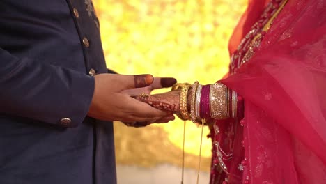 cinematic shot of a couple holding hands during muslim wedding in india