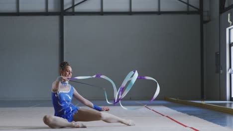 Female-gymnast-performing-at-sports-hall