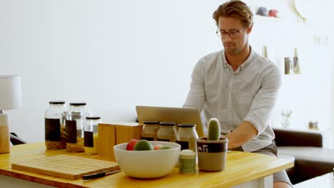 man using laptop at home 4k