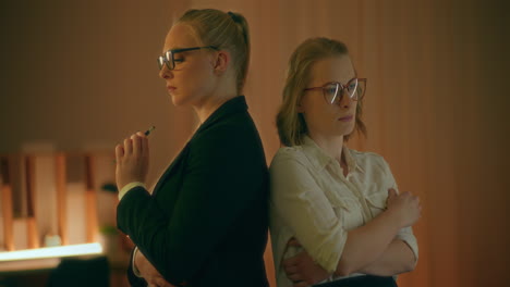 two women turned back to back close-up