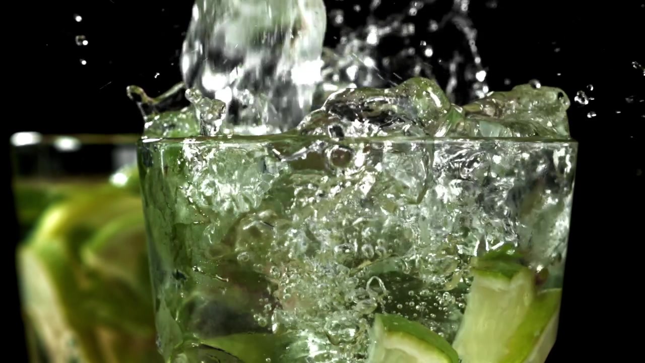 Refreshing Mojito Cocktail with Splashing Ice, Lime, and Mint