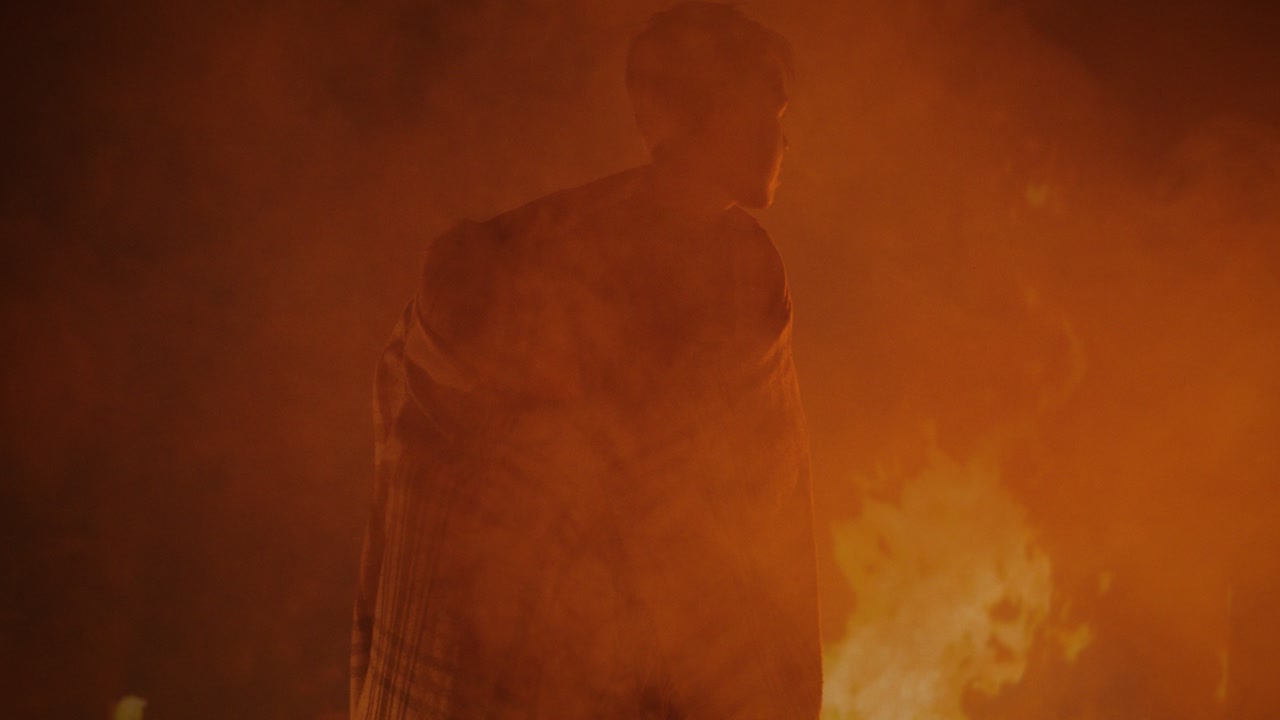 People in a smoky, fiery environment