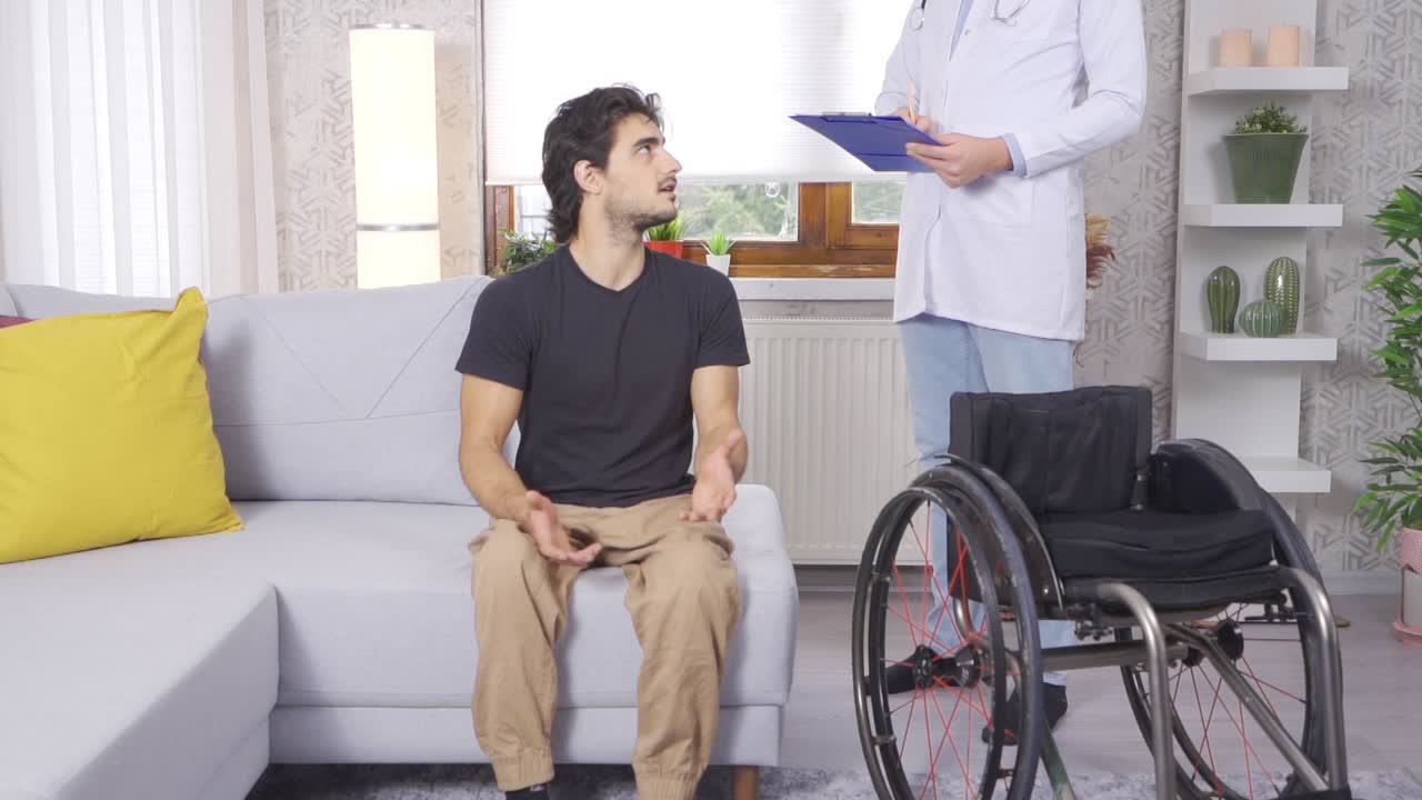 Human Health, Medical Examination of a Man in a Wheelchair by a Male Doctor. Slow Motion.