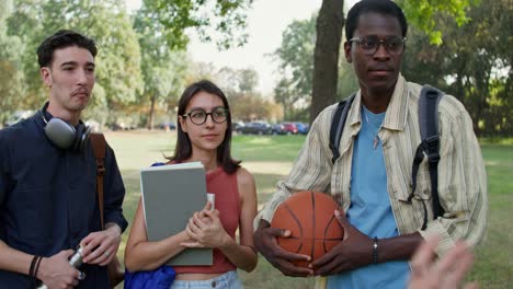 college students talking in a park