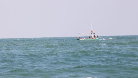 a small boat moves through wavy ocean waters.