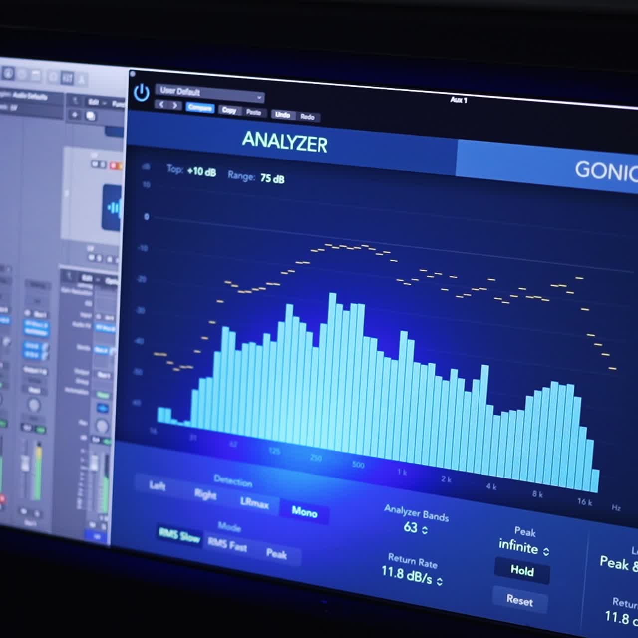 Music production in the modern professional studio. Screen with sound analyzing program is on. Close up