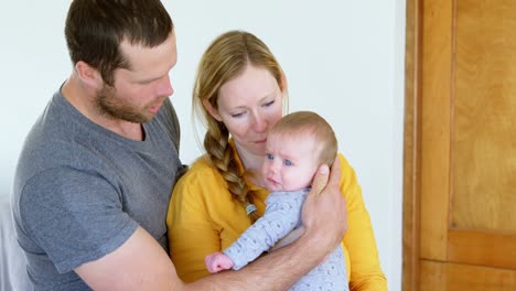 parents cradling their baby 4k