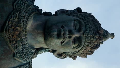 slow close up dolly forward shot of the vishnu at the gwk garuda wisnu kencana cultural park in bali indonesia in vertical