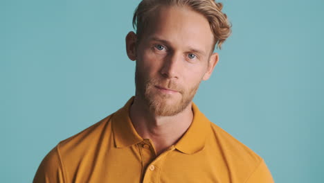 Scandinavian guy in polo T-shirt posing