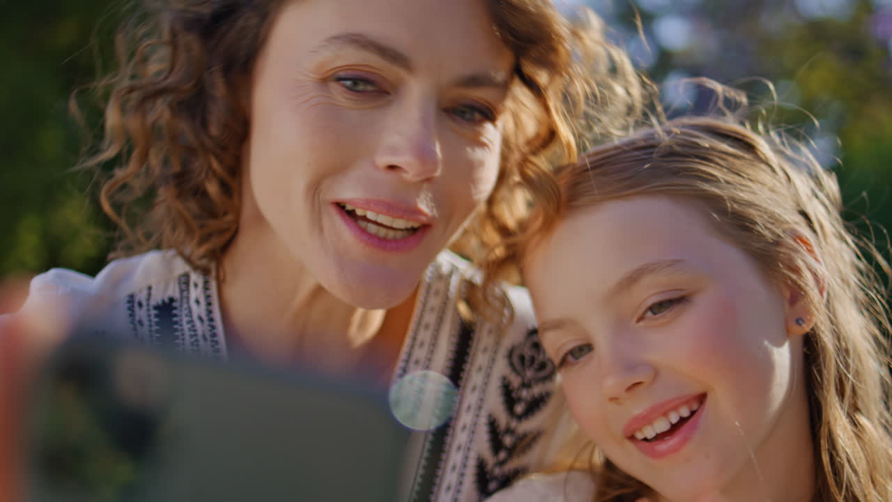 Mom child having videocall together on summer picnic closeup. Woman kid online