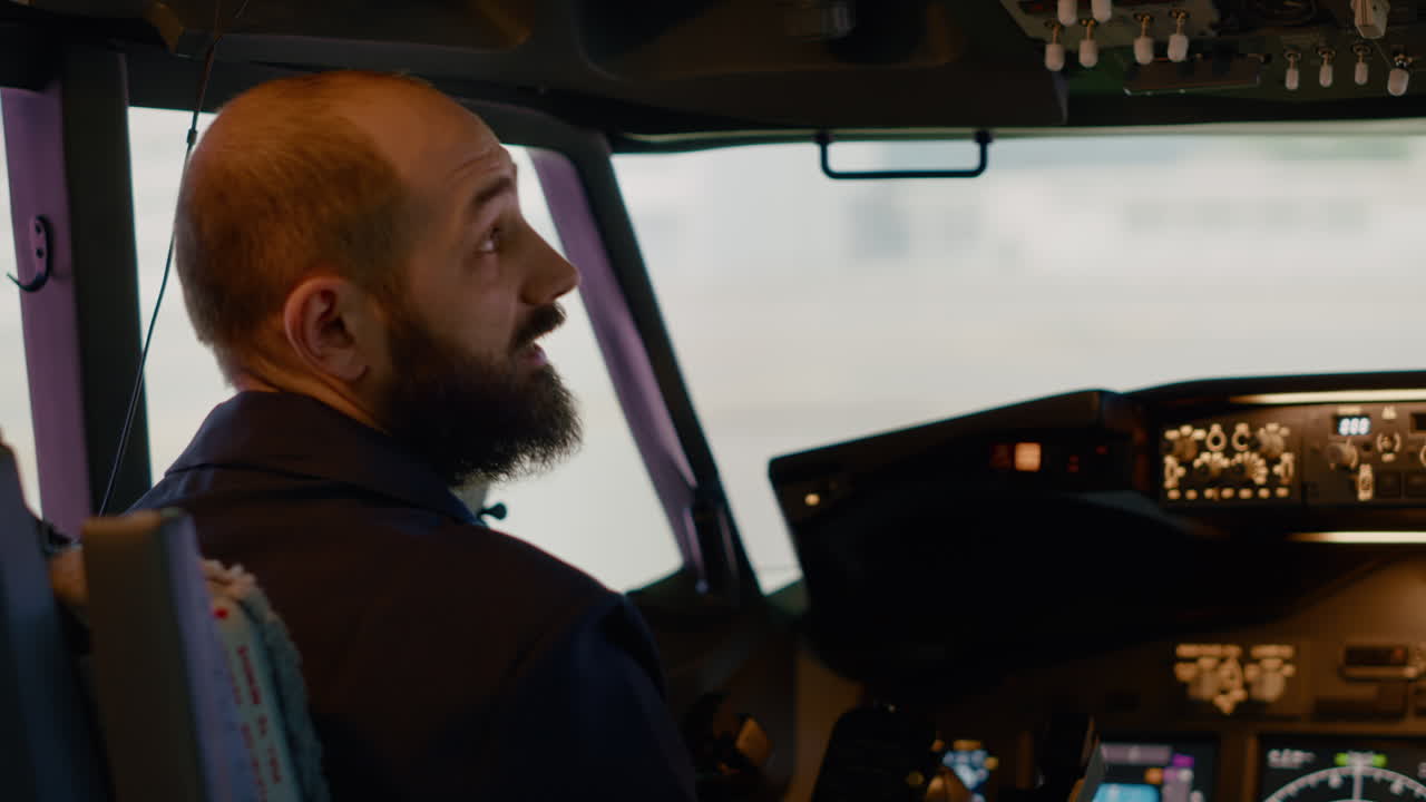 Airplane captain starting engine with power buttons on dashboard