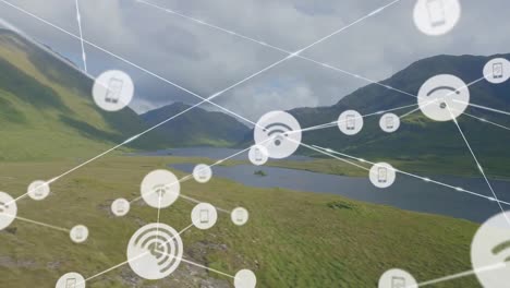 animation of connected icons over aerial view of lake between mountains against cloudy sky