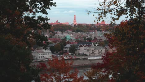 Lapso-De-Tiempo-Aéreo-De-La-Ciudad-De-Kaunas-Con-árboles-Dorados-De-Otoño-Al-Costado-Del-Video-Y-La-Iglesia-De-La-Resurrección-De-Cristo-En-Medio-De-La-Toma