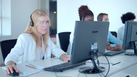 row of call center operators using computers