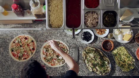 preparing vegetarian pizza in restaurant kitchen