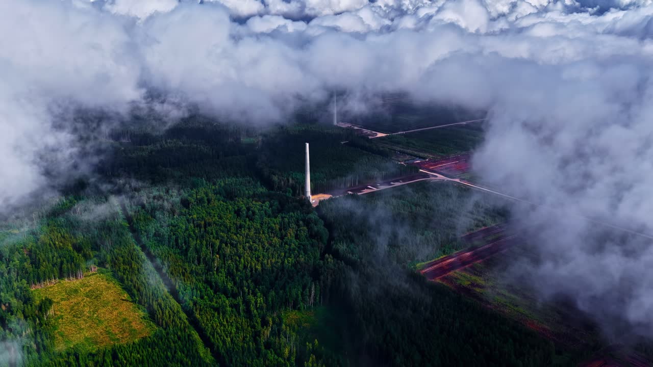 Aerial view of wind farm with turbines on cloudy day, renewable energy source